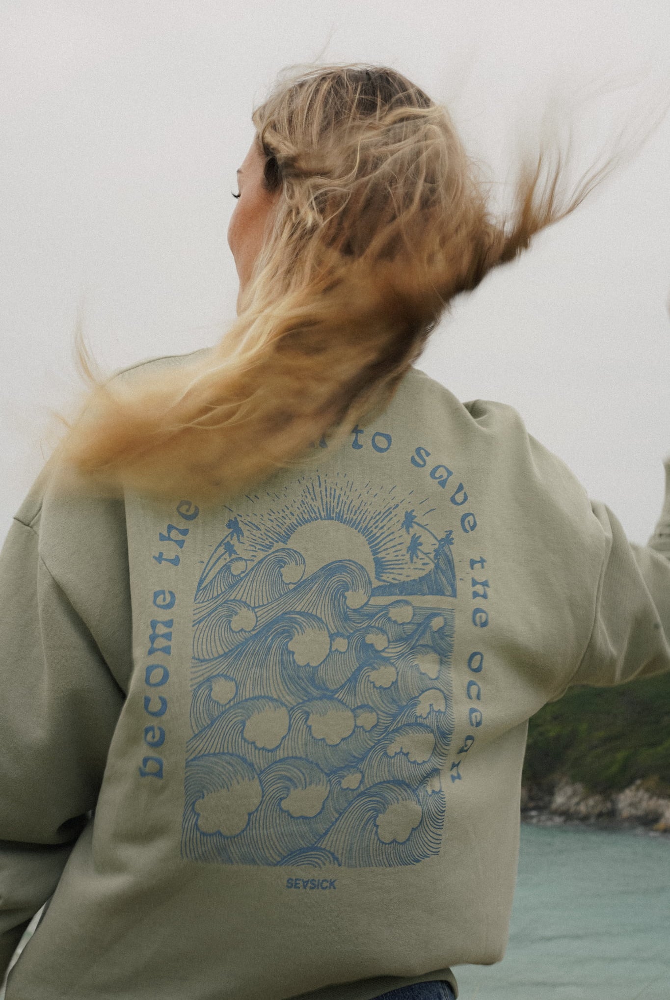 Green unisex sweater with bold back print and front logo stitch by Seasick Studio